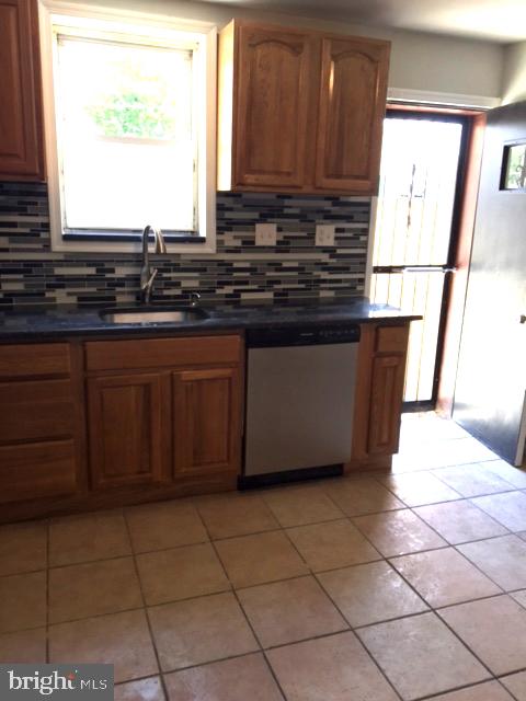 2445 East Huntingdon Street Philadelphia, PA 19125 - Photo 16 of 24 a kitchen with stainless steel appliances a sink window and cabinets