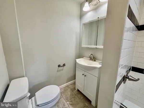 a bathroom with a sink a toilet and mirror