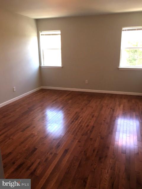 2445 East Huntingdon Street Philadelphia, PA 19125 - Photo 5 of 24 an empty room with wooden floor and windows
