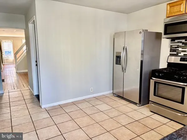 a kitchen with stainless steel appliances a refrigerator and a stove top oven