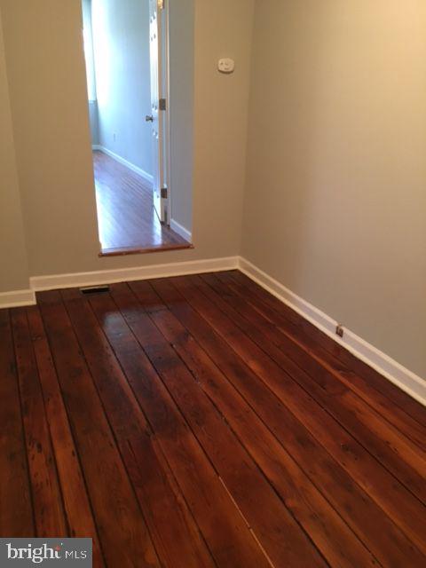 2445 East Huntingdon Street Philadelphia, PA 19125 - Photo 7 of 24 a view of an empty room with wooden floor and a window