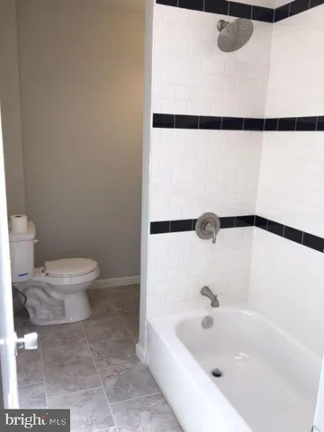 a bathroom with a bathtub and a toilet