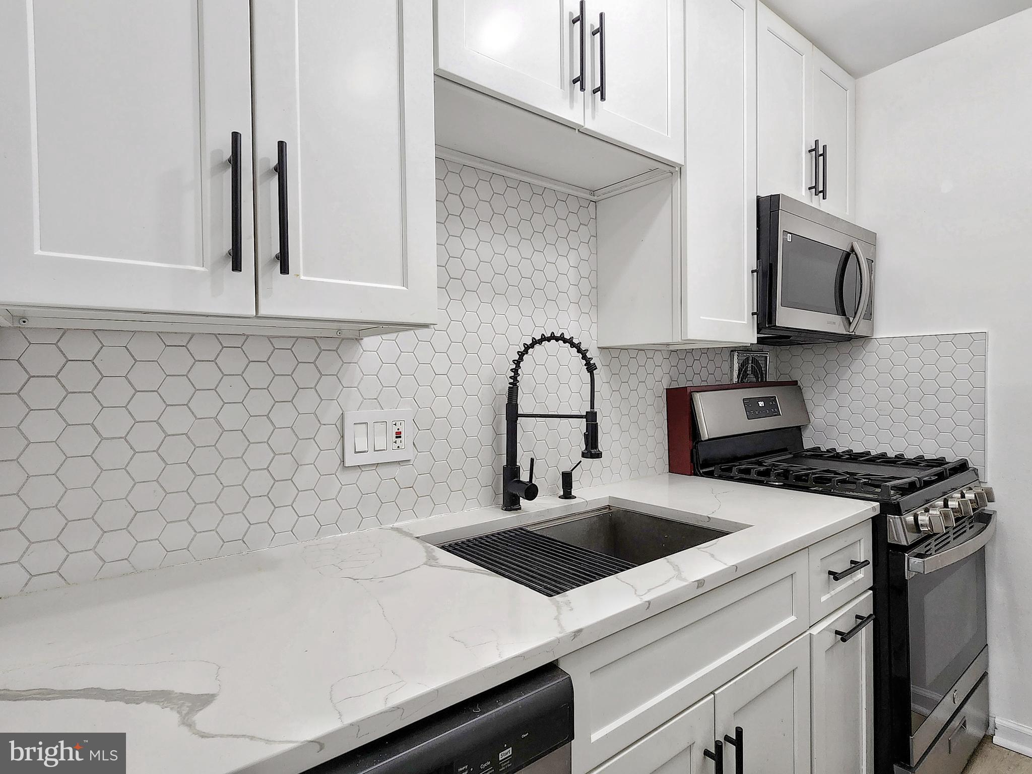 2901 Charing Cross Road, Unit 8 Falls Church, VA 22042 - Photo 14 of 40 a kitchen with a sink a stove and cabinets