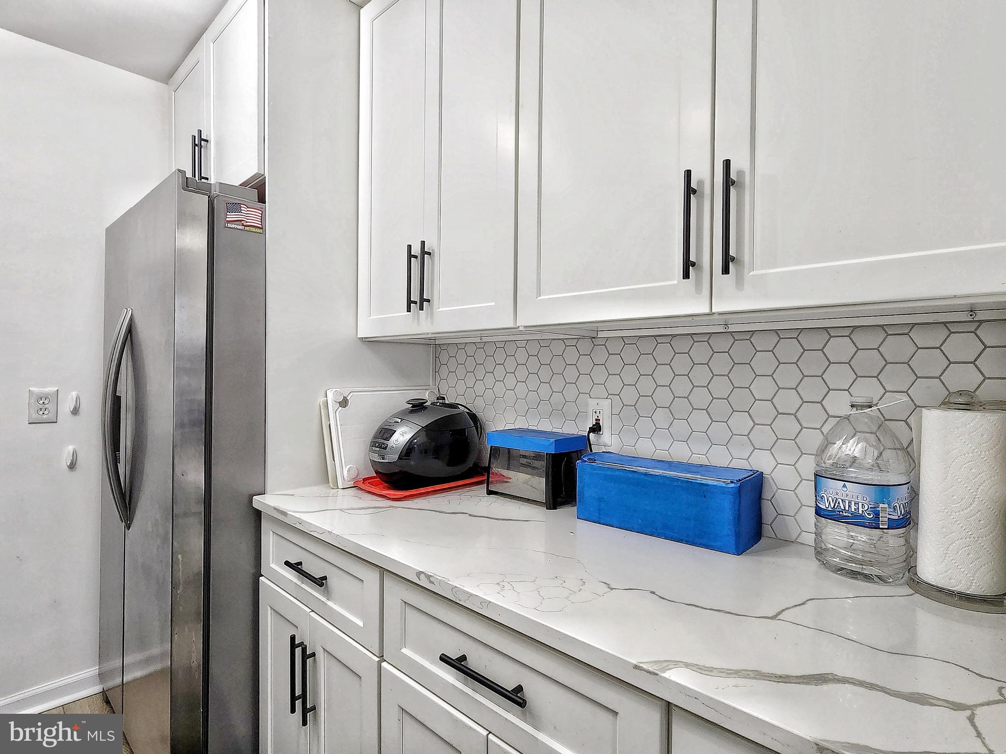 2901 Charing Cross Road, Unit 8 Falls Church, VA 22042 - Photo 15 of 40 a kitchen with stainless steel appliances a refrigerator and a sink