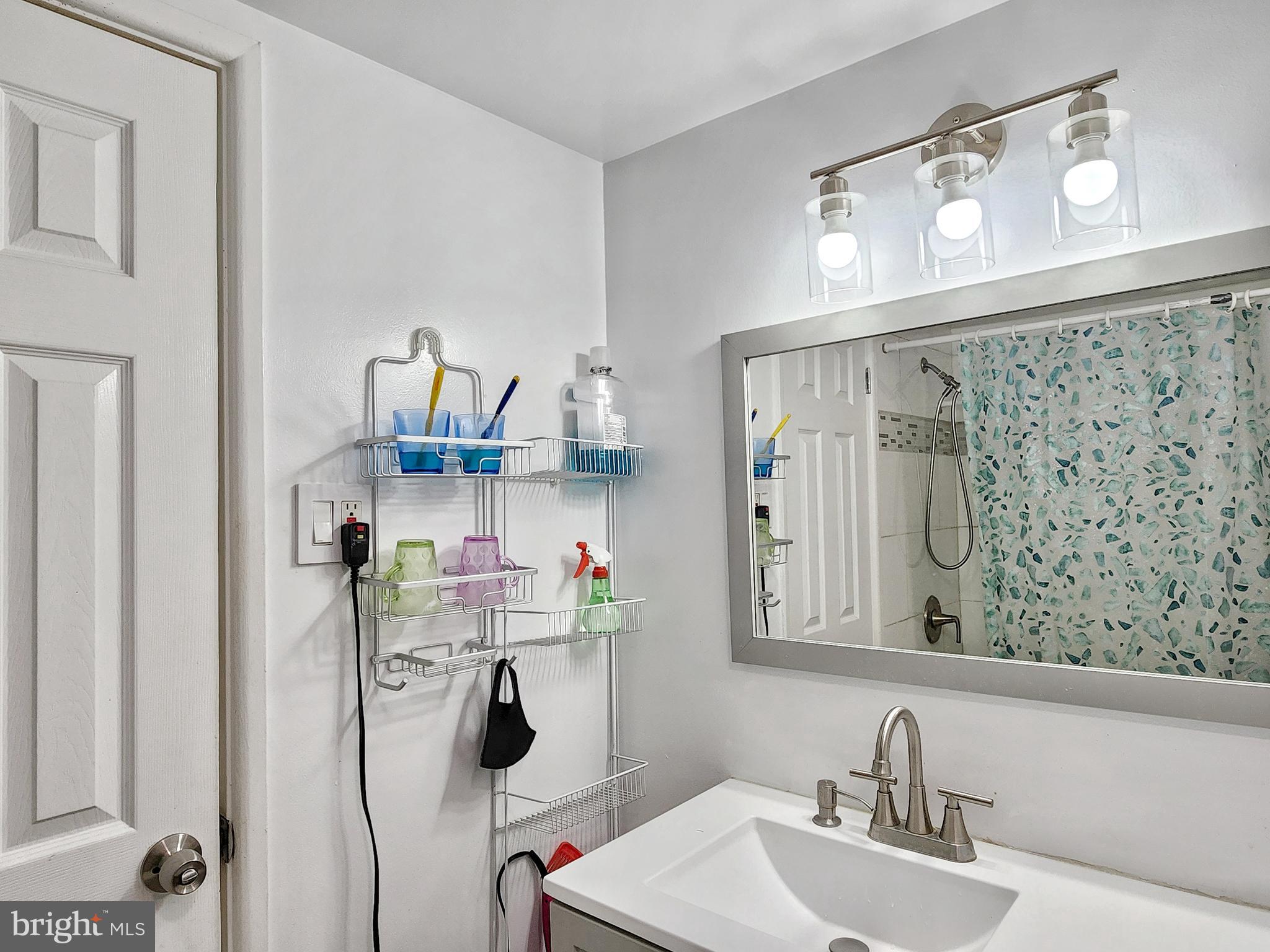 2901 Charing Cross Road, Unit 8 Falls Church, VA 22042 - Photo 22 of 40 a bathroom with a sink mirror and vanity