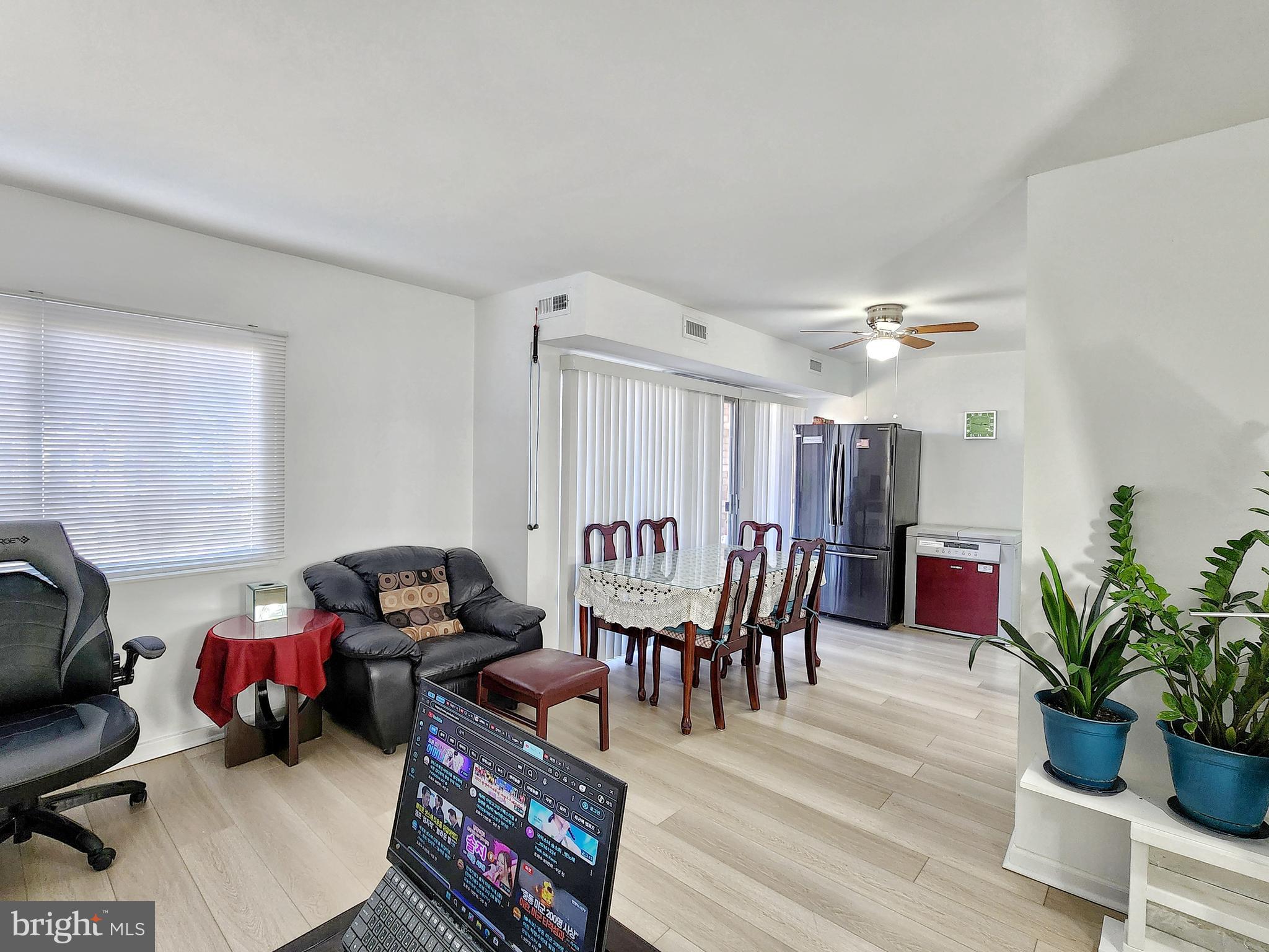 2901 Charing Cross Road, Unit 8 Falls Church, VA 22042 - Photo 9 of 40 a dining room with furniture potted plants and wooden floor