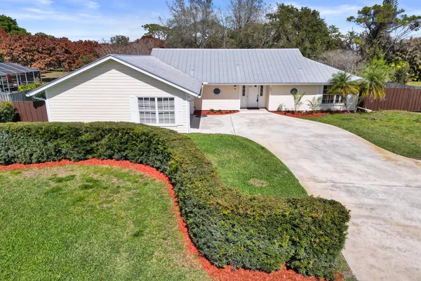 a view of a house with a garden and yard