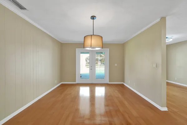 a view of a kitchen with a sink and dishwasher with wooden floor
