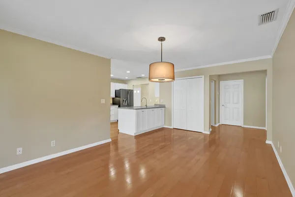 a open kitchen with kitchen island a sink appliances and a counter top space