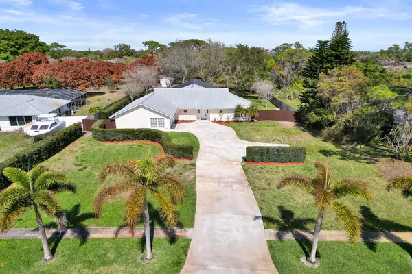 an aerial view of a house with a garden and plants