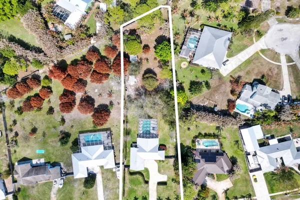 an aerial view of a house with a lake view