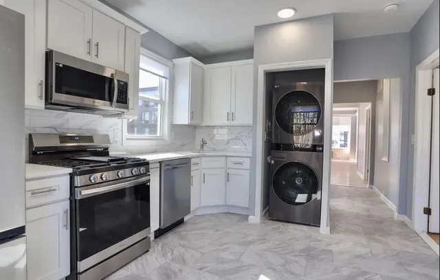 a kitchen with a stove top oven and cabinets