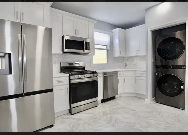 a kitchen with a refrigerator sink and stove top oven