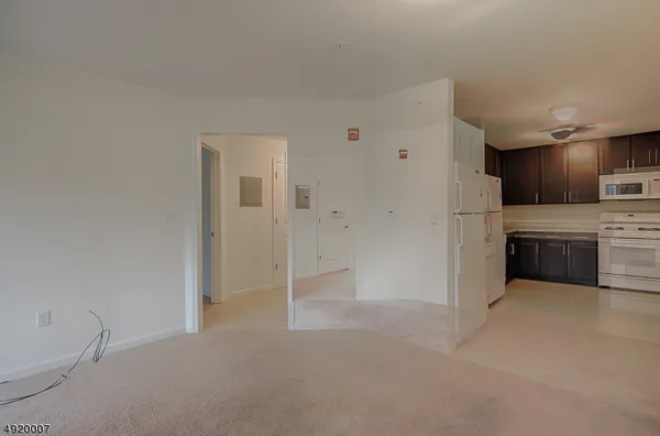 a view of a kitchen with a sink cabinets and a refrigerator