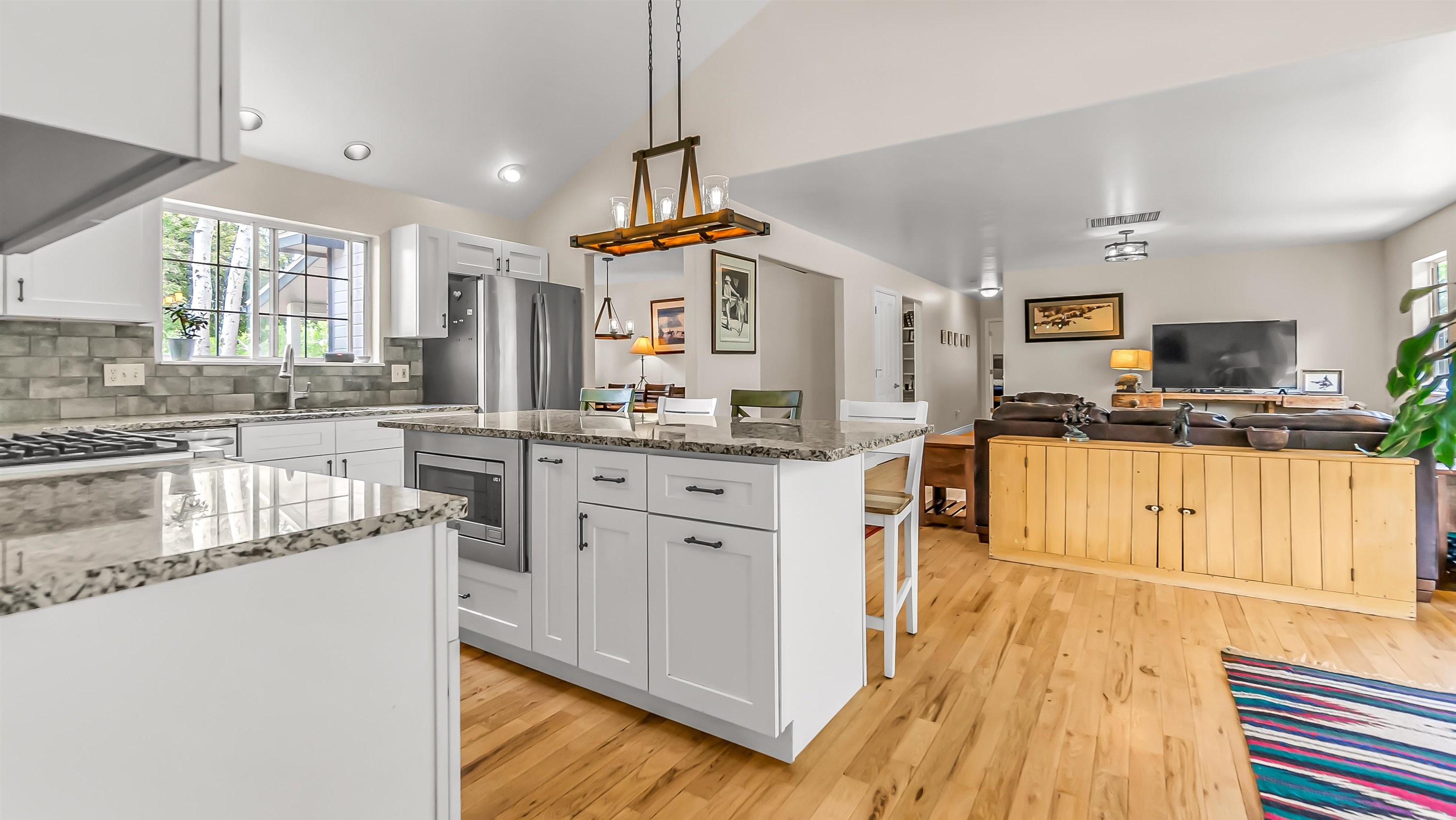 2346 Sundial Road Grand Junction, CO 81505 - Photo 14 of 41 a kitchen with stainless steel appliances granite countertop a sink cabinets and wooden floor