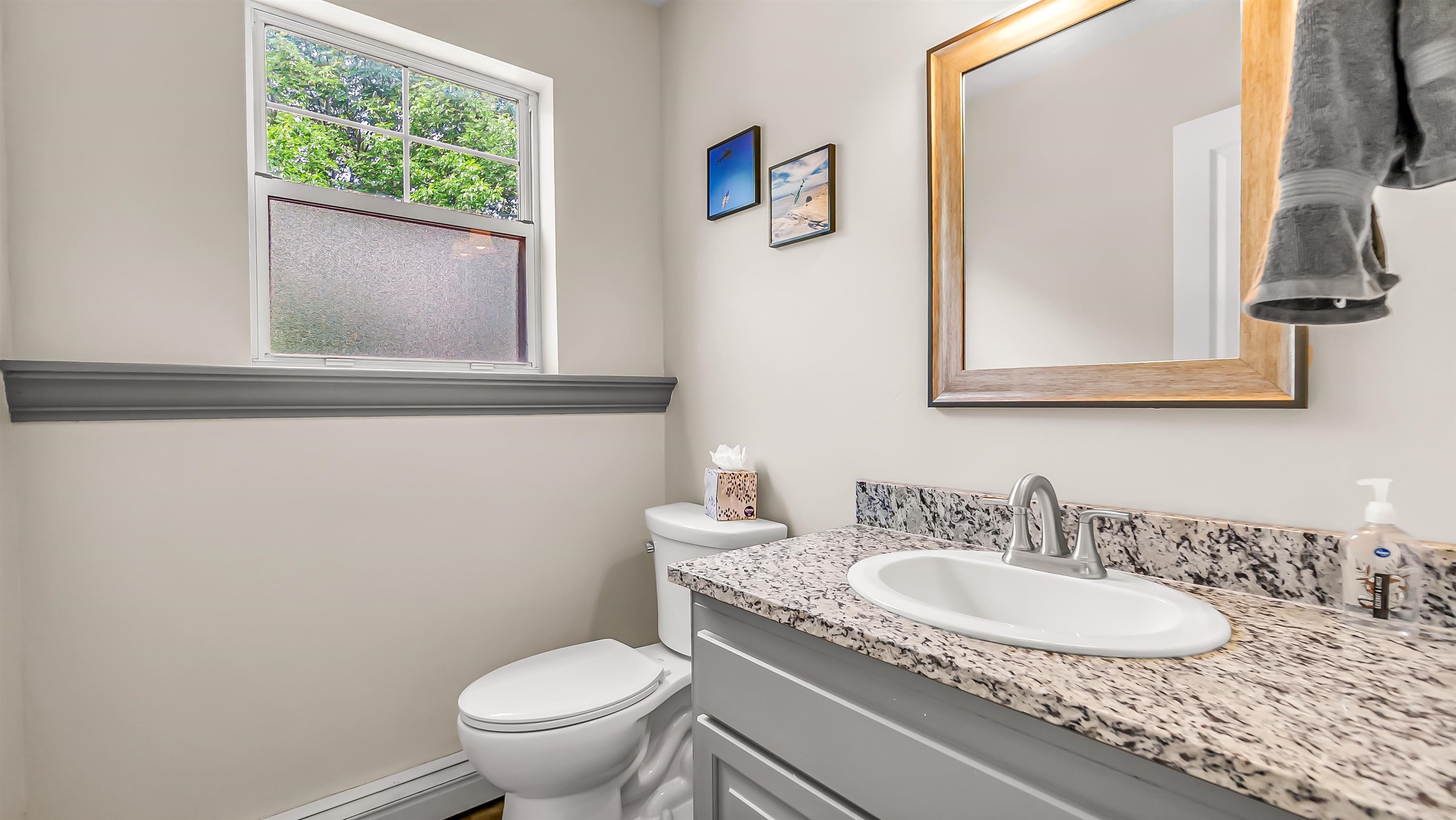 2346 Sundial Road Grand Junction, CO 81505 - Photo 16 of 41 a bathroom with a granite countertop sink a large mirror and a toilet