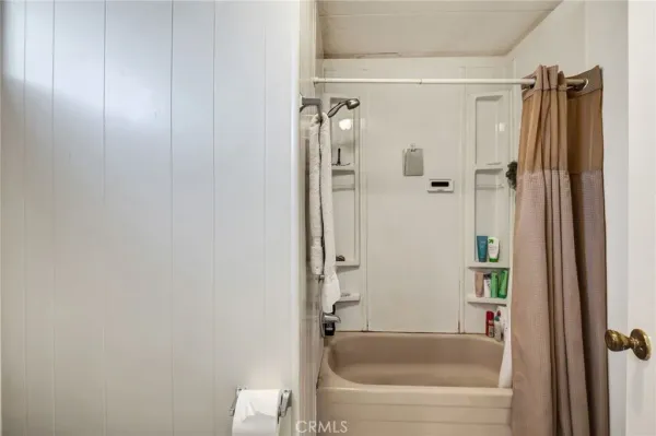 a bathroom with a bathtub and a shower