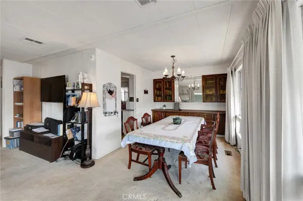 a view of a dining room with furniture and a window