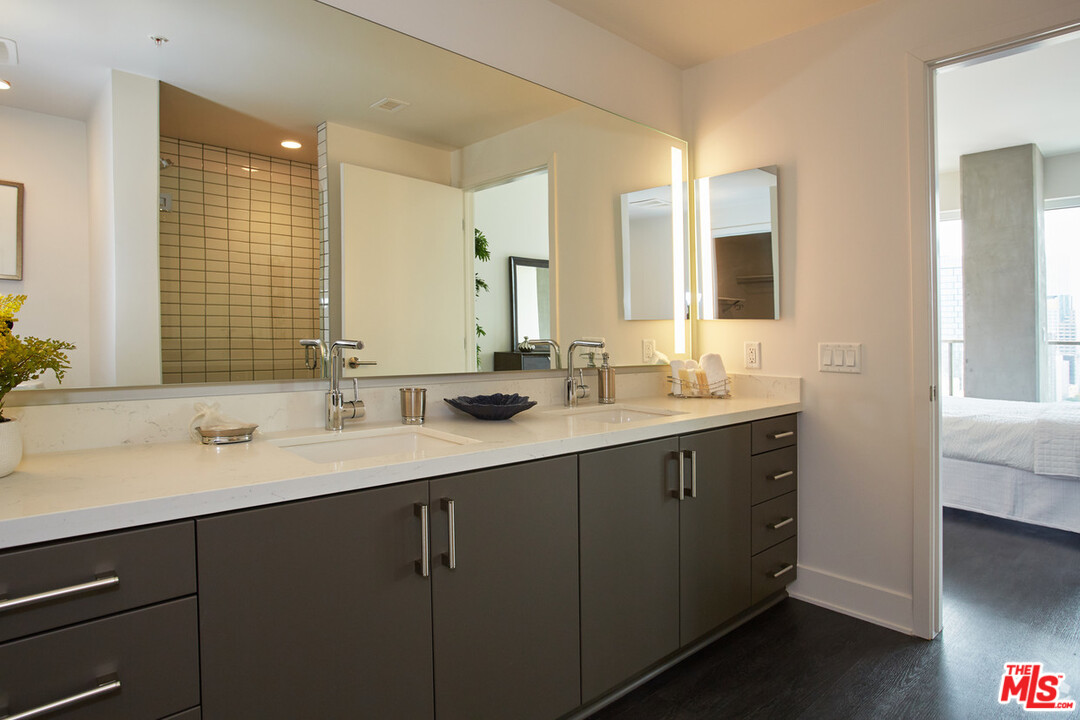 732 South Spring Street, Unit 918 Los Angeles, CA 90014 - Photo 13 of 31 a bathroom with a sink double vanity granite and a mirror