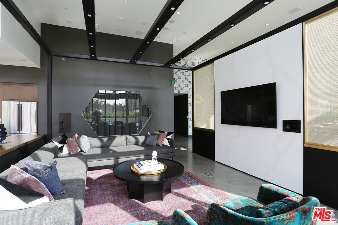 732 South Spring Street, Unit 918 Los Angeles, CA 90014 - Photo 18 of 31 a living room with furniture and a flat screen tv
