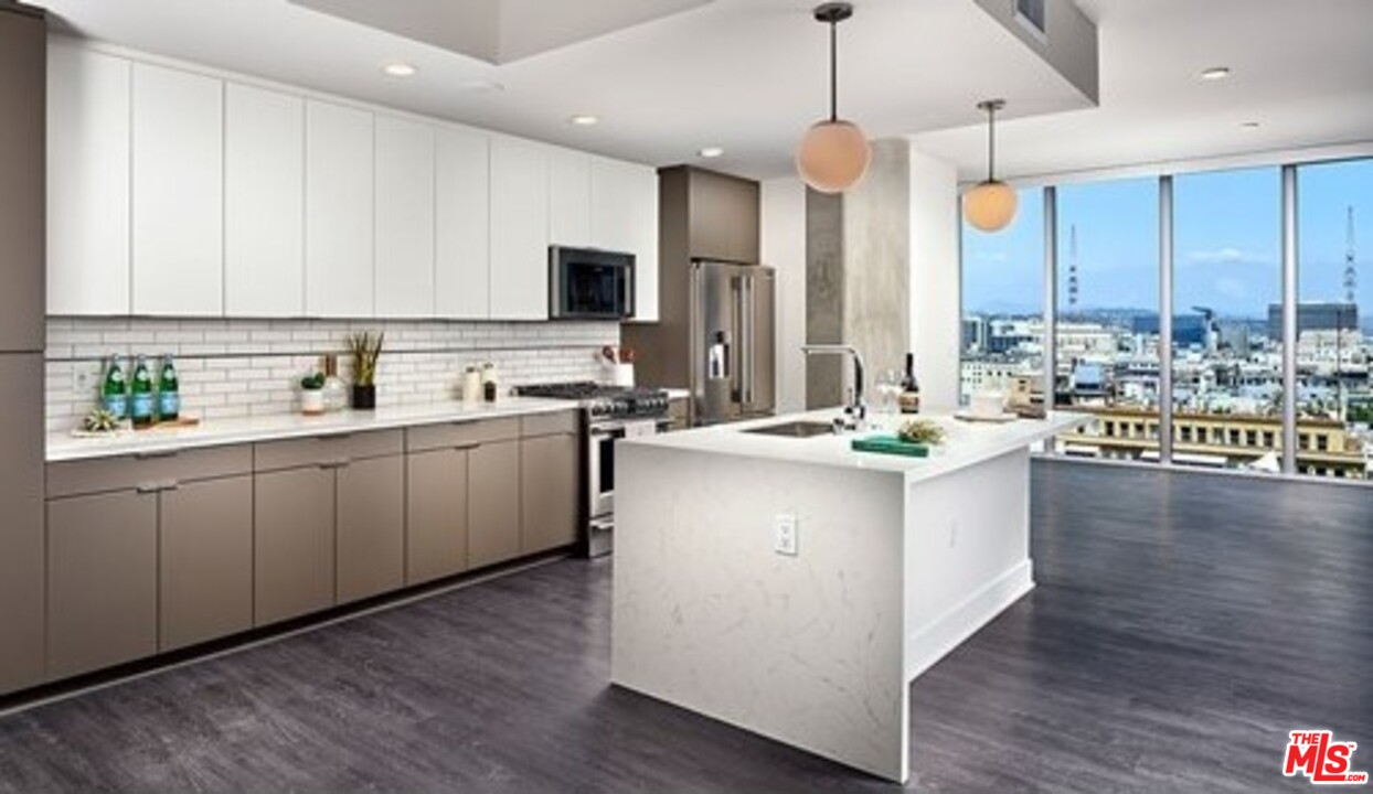 732 South Spring Street, Unit 918 Los Angeles, CA 90014 - Photo 2 of 31 a kitchen with a sink cabinets and window