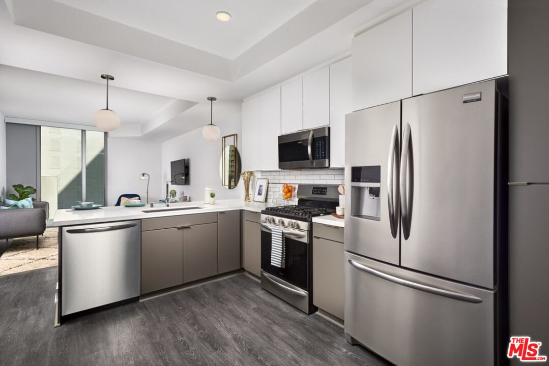 732 South Spring Street, Unit 918 Los Angeles, CA 90014 - Photo 7 of 31 a kitchen with stainless steel appliances a refrigerator sink and microwave