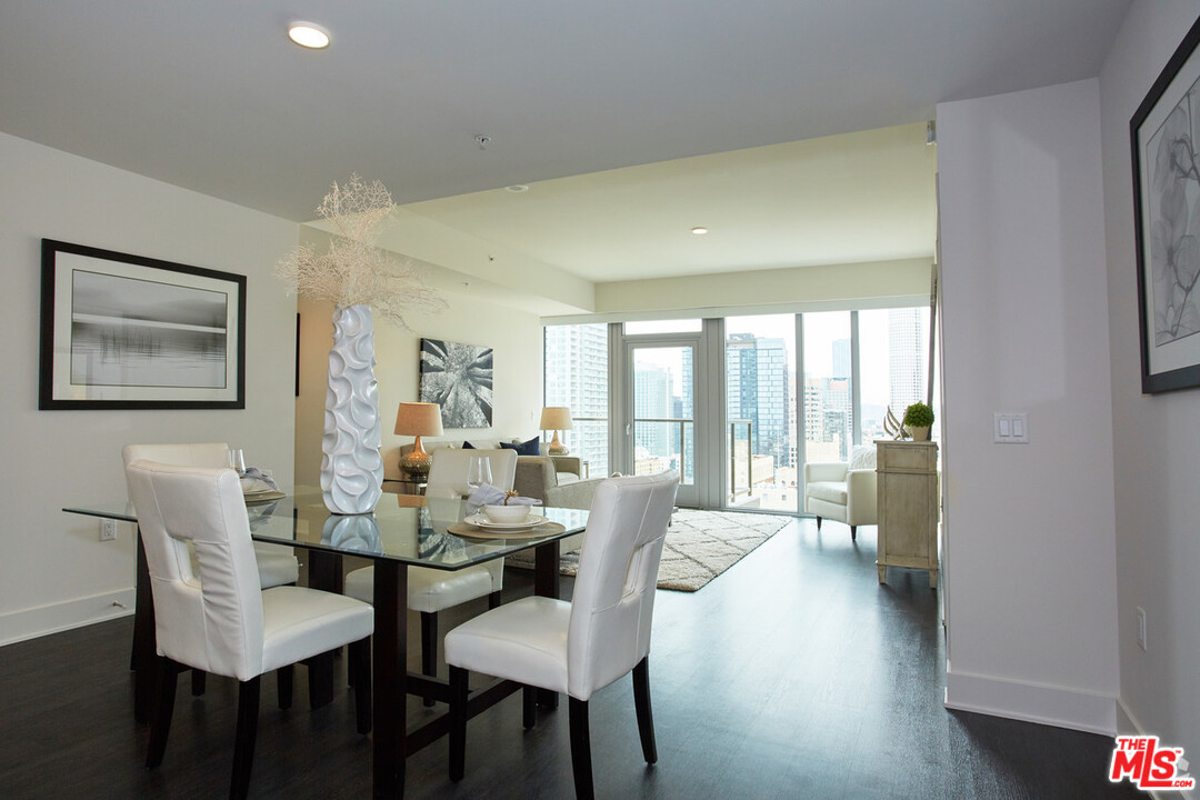 732 South Spring Street, Unit 918 Los Angeles, CA 90014 - Photo 8 of 31 a view of a dining room with furniture and wooden floor