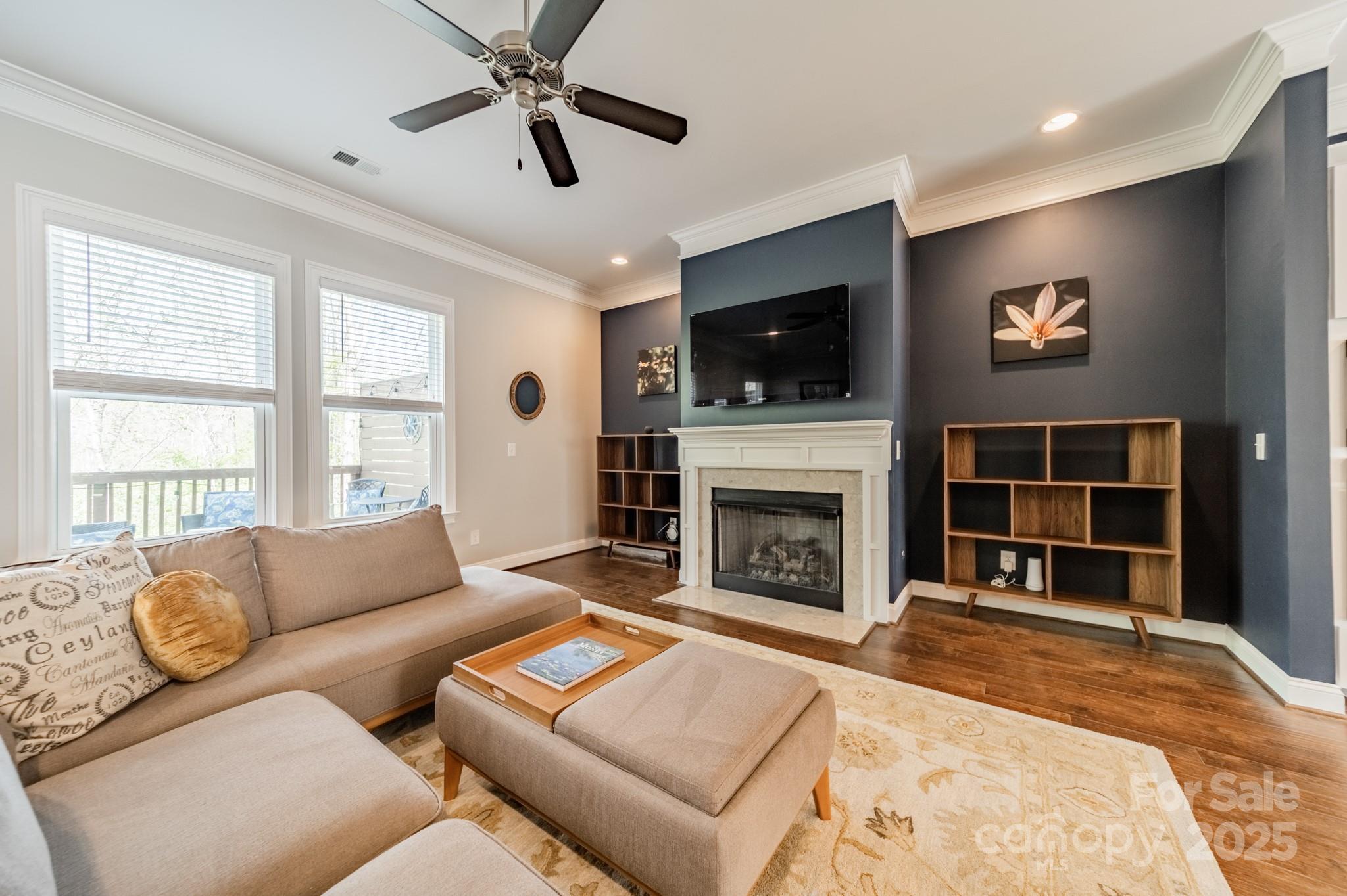 15133 Rocky Bluff Loop Davidson, NC 28036 - Photo 12 of 47 a living room with furniture a flat screen tv and a fireplace