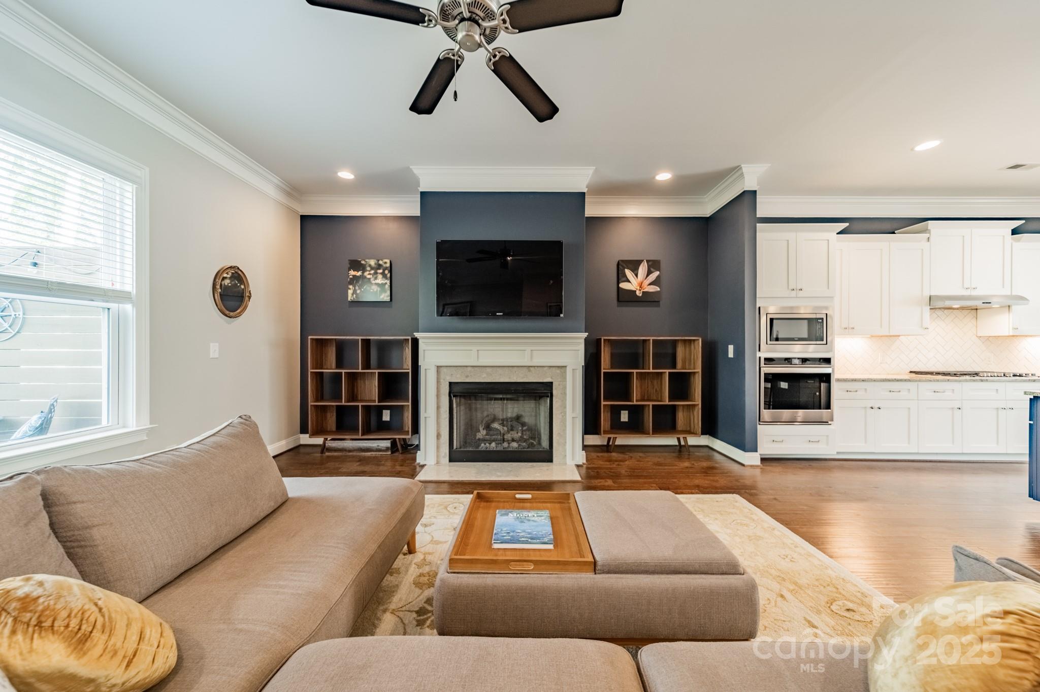 15133 Rocky Bluff Loop Davidson, NC 28036 - Photo 13 of 47 a living room with furniture flat screen tv and a fireplace