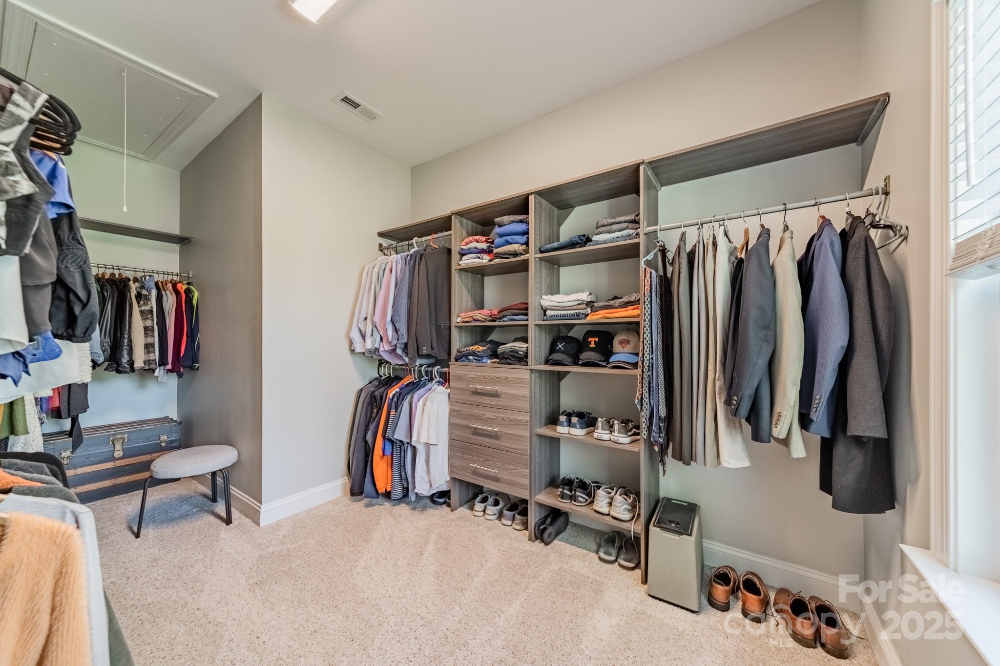 15133 Rocky Bluff Loop Davidson, NC 28036 - Photo 26 of 47 a view of walk in closet with clothes and shoes