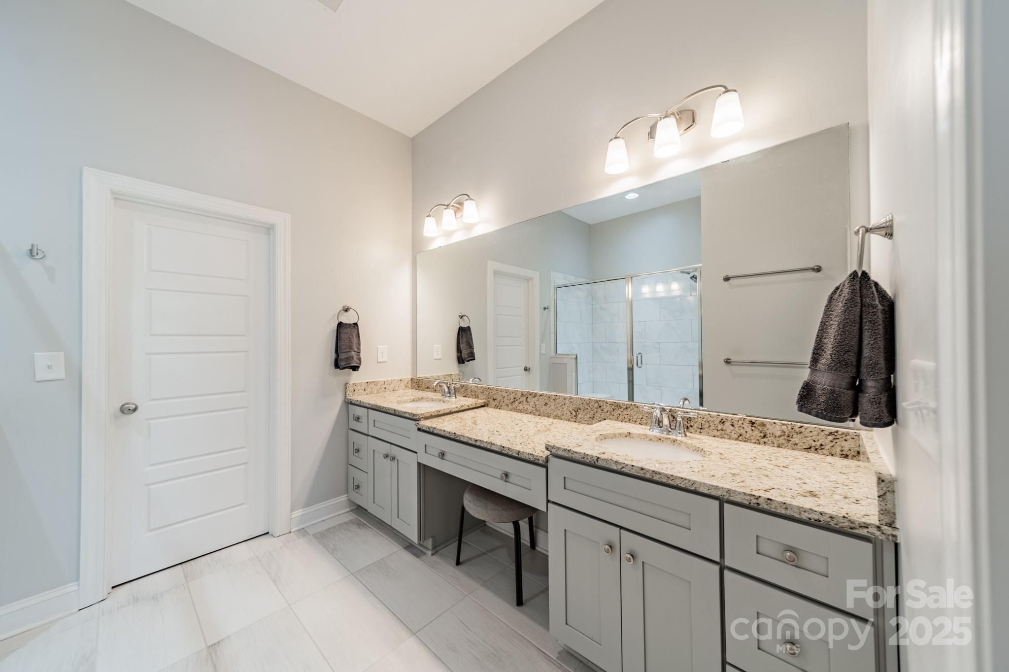 15133 Rocky Bluff Loop Davidson, NC 28036 - Photo 27 of 47 a bathroom with a granite countertop sink a large mirror and a shower