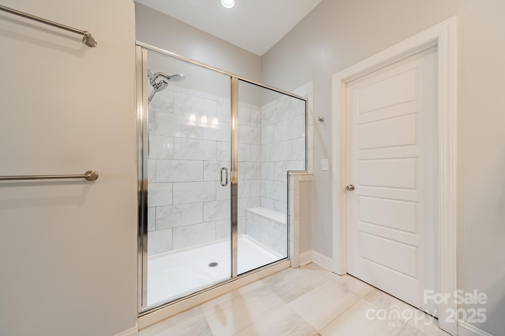 15133 Rocky Bluff Loop Davidson, NC 28036 - Photo 28 of 47 a bathroom with a glass shower door