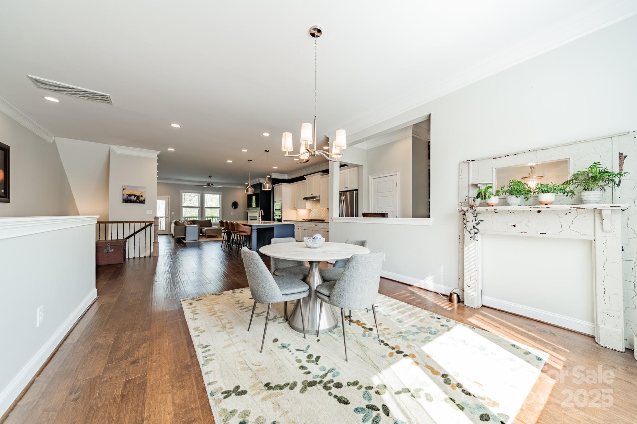 15133 Rocky Bluff Loop Davidson, NC 28036 - Photo 5 of 47 a view of a dining room with furniture and wooden floor