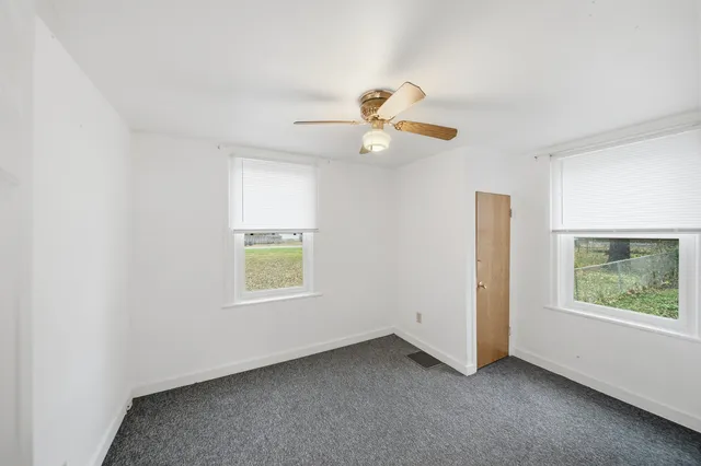 an empty room with window and windows