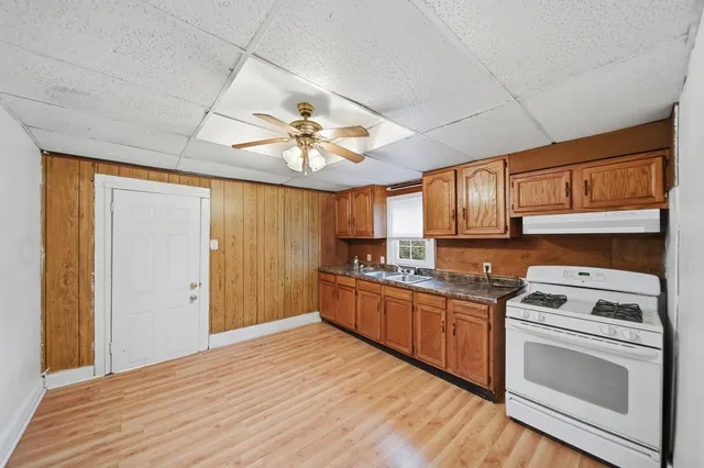 a kitchen with stainless steel appliances granite countertop a stove cabinets and entryway