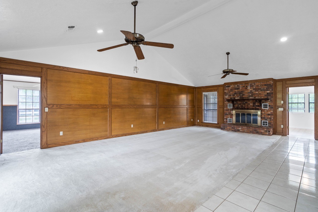 13180 Morgan Drive Splendora, TX 77372 - Photo 6 of 38 So much room in this living room. Notice the beautiful block paneling. Enjoy the wood burning fireplace during chilly nights. Fresh paint throughout.