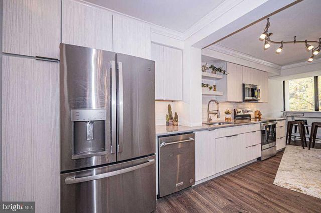 a kitchen with kitchen island a sink appliances and cabinets