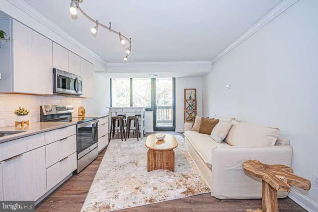a living room with furniture a flat screen tv and a large window