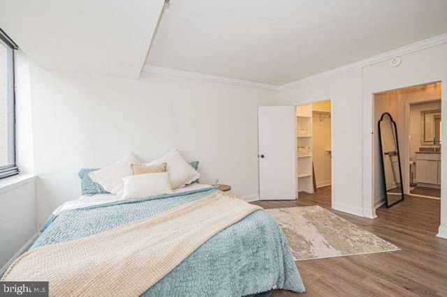 a bedroom with a bed and a dresser