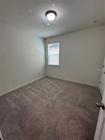 an empty room with a fan