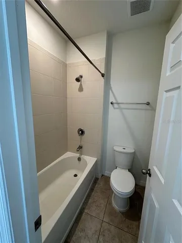 a bathroom with a bathtub and toilet