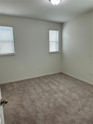 a bathroom with a toilet and a shower curtain
