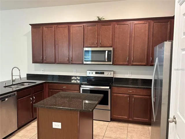 a kitchen with a sink stove and microwave