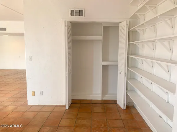 a living room with furniture ceiling fan and a large window