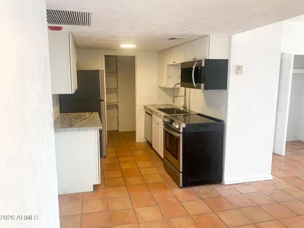 a kitchen with a sink a refrigerator and a stove