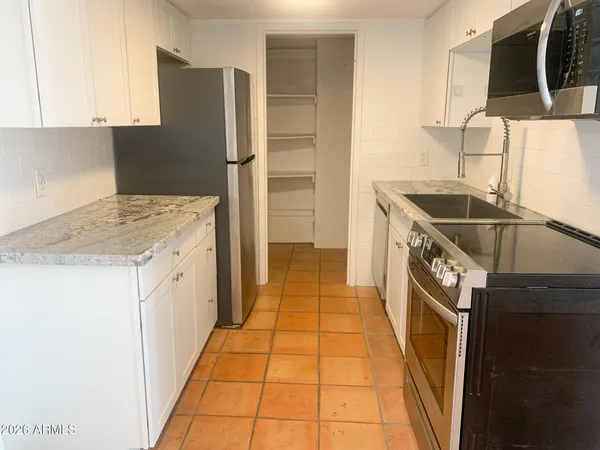 a kitchen with a refrigerator and a sink