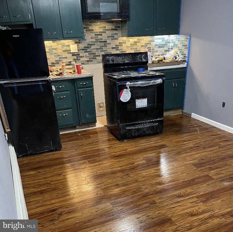 46 South State Road Upper Darby, PA 19082 - Photo 23 of 32 a kitchen with stainless steel appliances wooden floor and a sink