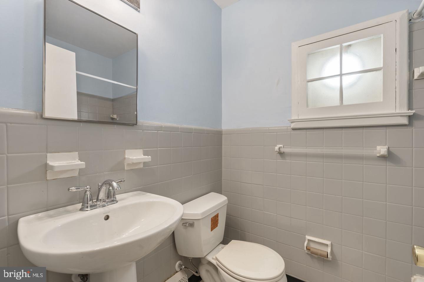 46 South State Road Upper Darby, PA 19082 - Photo 10 of 32 a bathroom with a toilet a sink and mirror