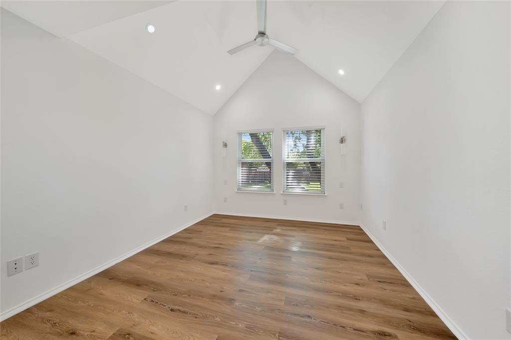 2909 Normandy Court Euless, TX 76039 - Photo 25 of 36 an empty room with wooden floor and windows