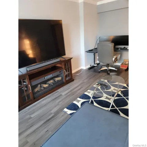 a living room with furniture and a painting on the wall